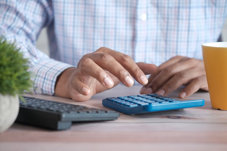 Close up of man using calculator